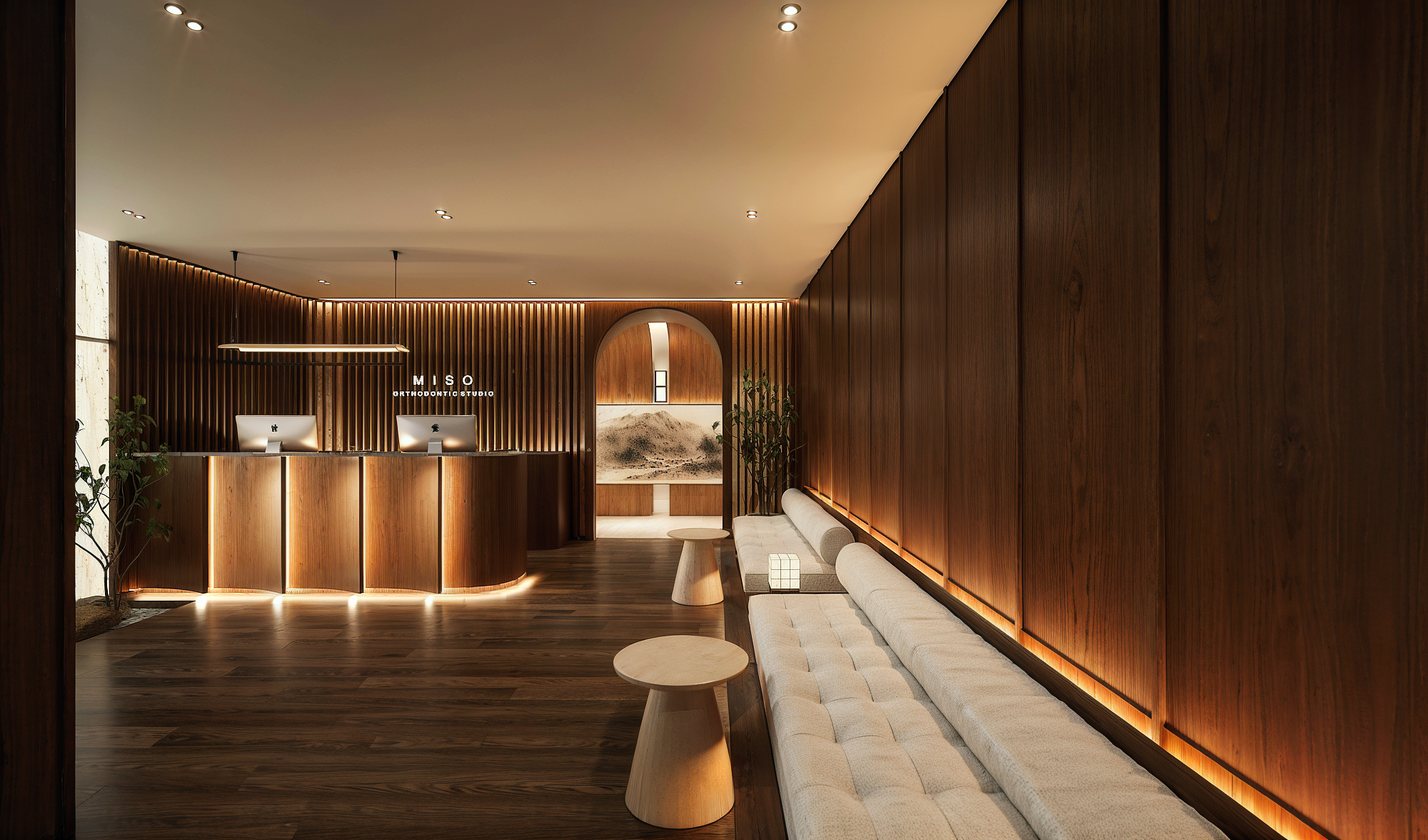 Reception at Miso Orthodontic Studio with backlit signage and a walnut slat wall